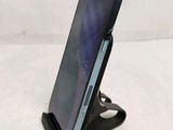 a phone that is sitting on a stand on a table