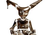 statue of a woman sitting on a chair with a knife in her hand