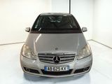 a silver car that is parked in a white room