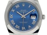 a close up of a watch with roman numerals on the face