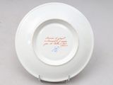 a white plate with a red and blue design on it