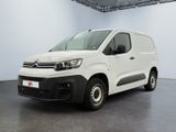 the white van is parked in a large room with a black floor