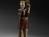 an image of a wooden statue of a man holding a child