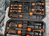 deux outils noirs et orange rangés dans un coffret posé sur une table