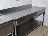 two stainless steel sinks in a kitchen with tiled walls