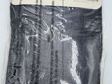a bag of black fabric on a white surface