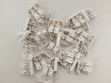 a lot of white legos sitting on a white surface