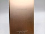 the back of a gold tablet computer sitting on top of a white surface