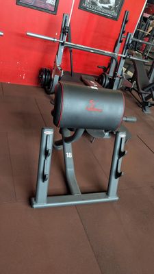 an image of a gym room with a bench and weights