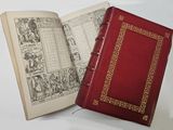 a red book that is open on a white table