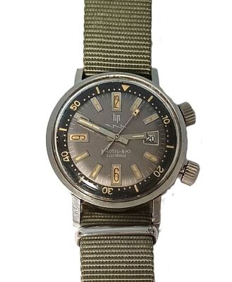 an image of a military watch with a green strap