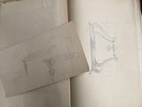 an open book with a drawing of a chair on top of it