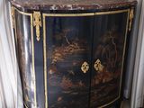 a black and gold cabinet with a marble top