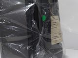 a black suitcase wrapped in plastic on a white surface