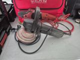 a sander and a tool bag on a table