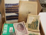 many books in a box on a table