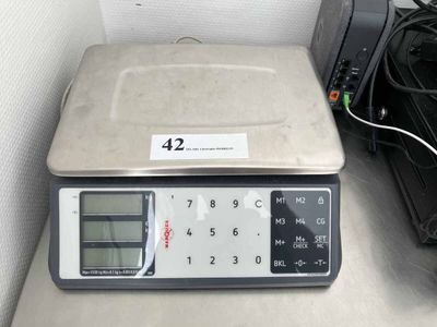 a digital scale sitting on top of a counter next to a printer