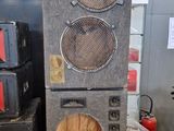 two speakers sitting on top of each other in a room