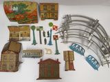 a lot of toy train tracks and buildings on the table