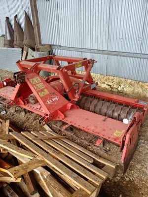 un tracteur garé dans une grange avec une charrue