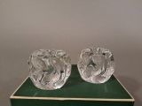 two clear glass vases sitting on a green box