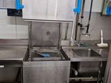 a kitchen with a sink, stove, and faucet in it