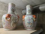 two vases that are sitting on a shelf