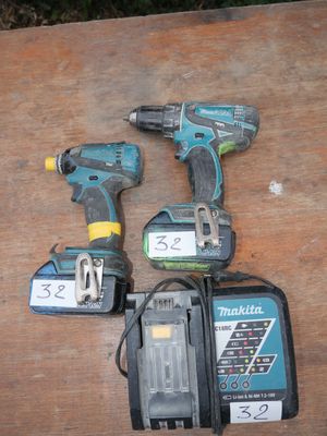 three cordless drillers on a wooden table