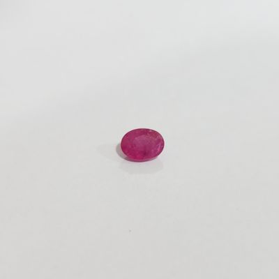 une pierre rose sur une surface blanche