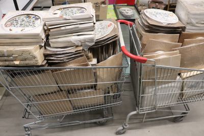 several shopping carts filled with boxes and bags in a store