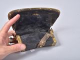 a hand that is holding an old purse