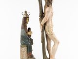 two figurines of jesus and a woman with a cross