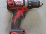 a cordless drill that is laying on the floor