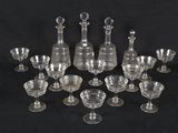 an image of a group of wine glasses and decanters on a black background