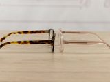 glasses on a wooden table with a white wall in the background
