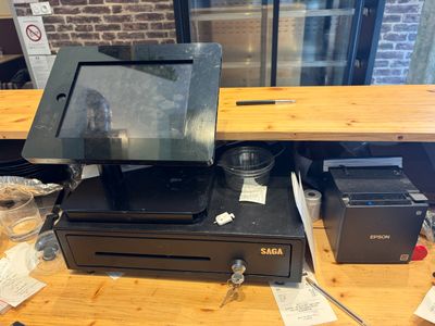 a cash register sitting on top of a wooden counter