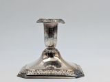 a silver plated candle holder on a white background