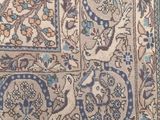 an antique persian rug with a blue border and a floral design