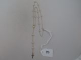 a rosary and a cross hanging on a wall