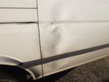 a white van that is parked on the side of the road