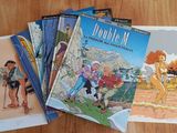several children ' s books sitting on top of a wooden table