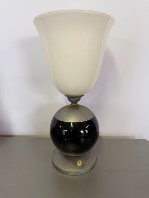 an image of a black and white glass lamp on a table