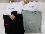 three t - shirts with japanese writing are on display on a shelf