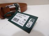 a brown belt with a tag on it on a table