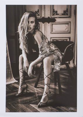 black and white photograph of a woman sitting on a chair