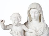 a statue of a woman holding a baby in her lap