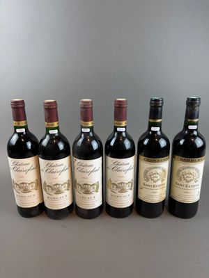 six bottles of wine lined up in a row on a table