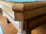 a pool table with a blue cloth on it