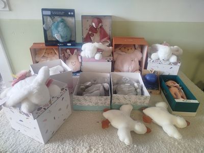 many stuffed animals in boxes on the table