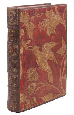 un vieux livre avec un oiseau et des fleurs sur la couverture